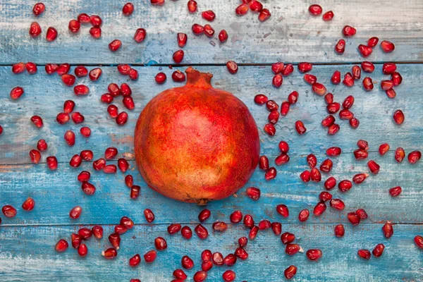 Pomegranate on vintege blue background — Stock Photo, Image