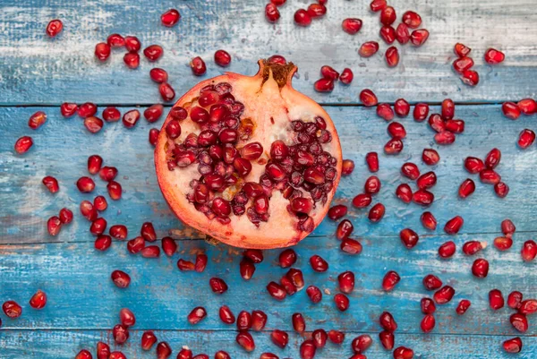 Pomegranate on vintege blue background — Stock Photo, Image