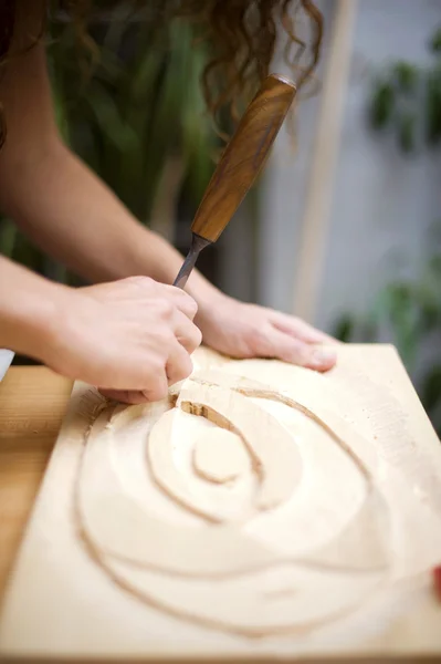 Wood carving on table with artist — Stock Photo, Image