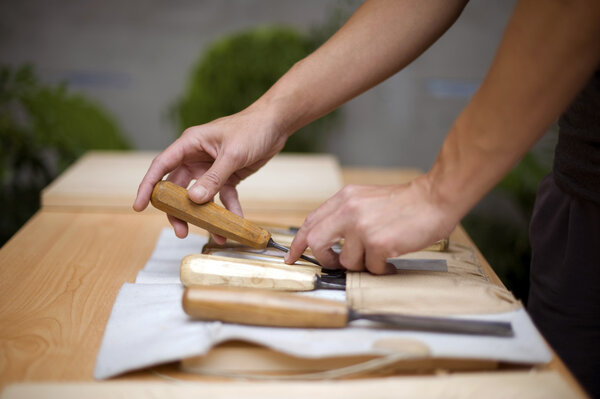 Wood carving on table with artist