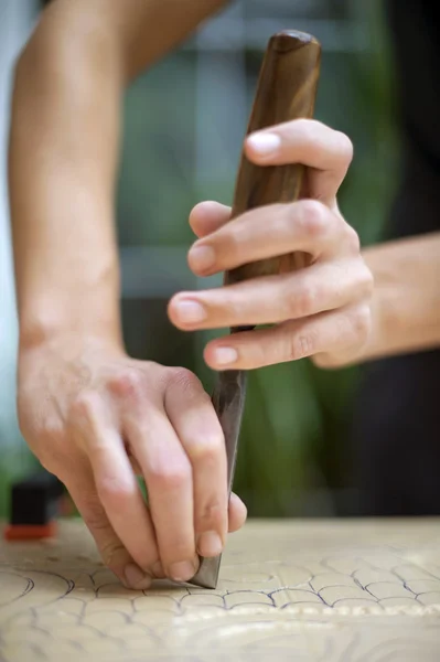 Wood carving on table with artist — Stock Photo, Image