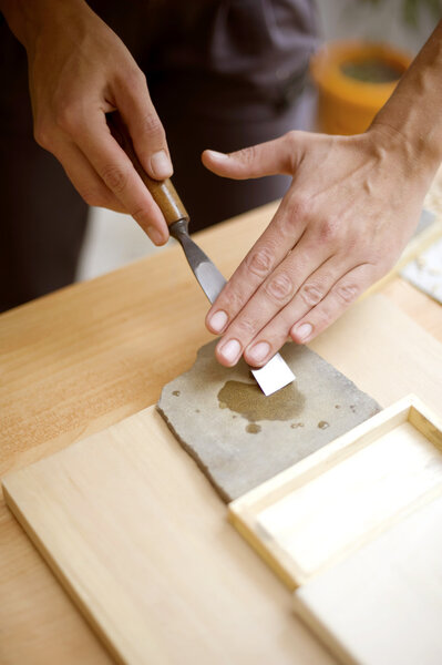 Wood carving on table with artist