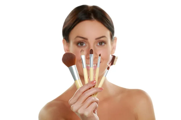 Woman holding make-up brushes — Stock Photo, Image