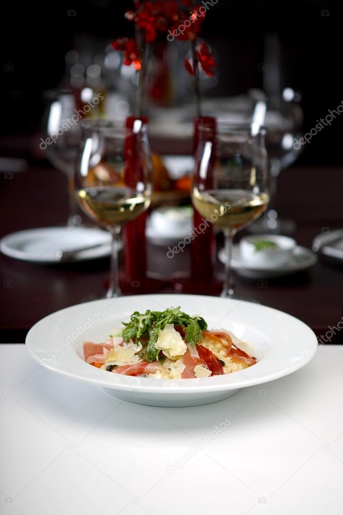 delicious salad with wine glasses