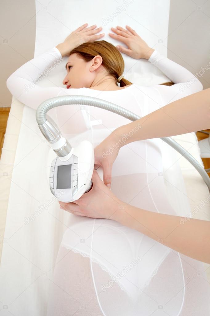 Woman having a treatment against cellulite with LPG machine