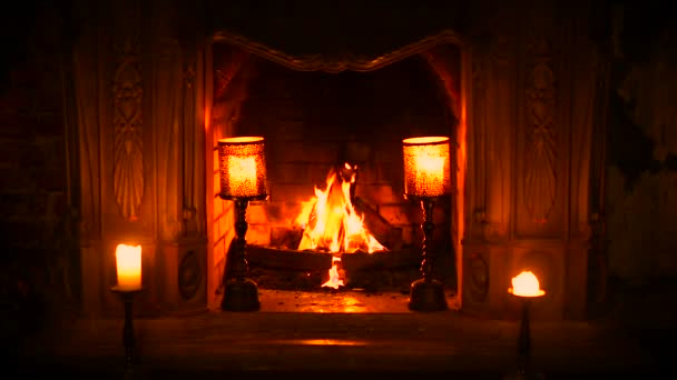 The old Gothic fireplace is a fire. Burning candles. Condition of peace and relaxation — Stock Video