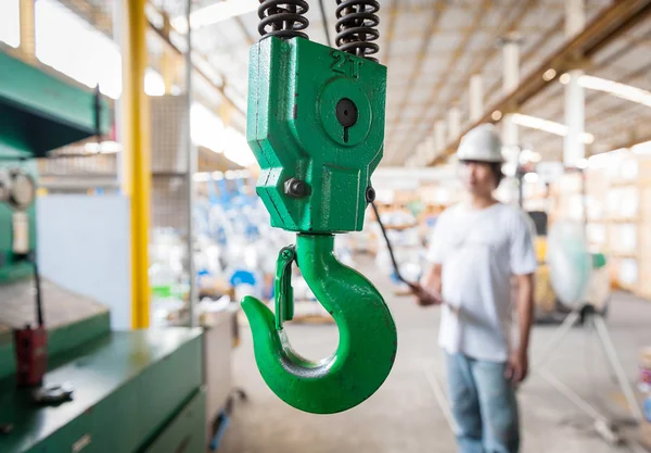 Industrial crane with valve warehouse background — Stock Photo, Image