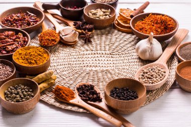 Ahşap masada baharatlar ve otlar.