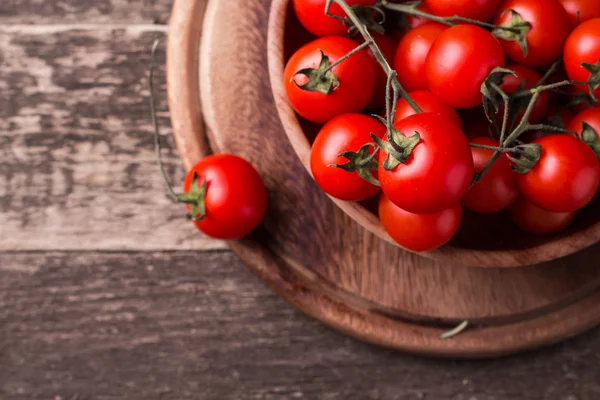 Cherry tomatoes on wooden background — Stock Photo, Image