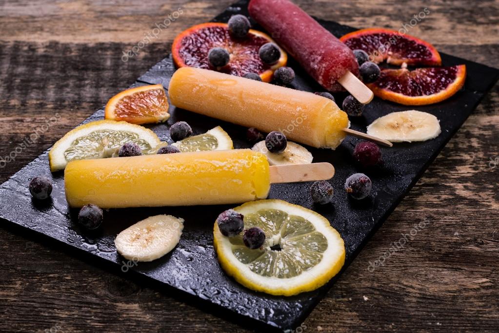 Colorful popsicles with fresh fruits. Summer refreshing icecream Stock