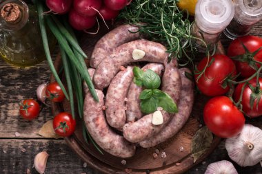 Taze kasap et ürün yelpazesine ahşap masa üzerinde taze biberiye ile süslenmiş kesmek