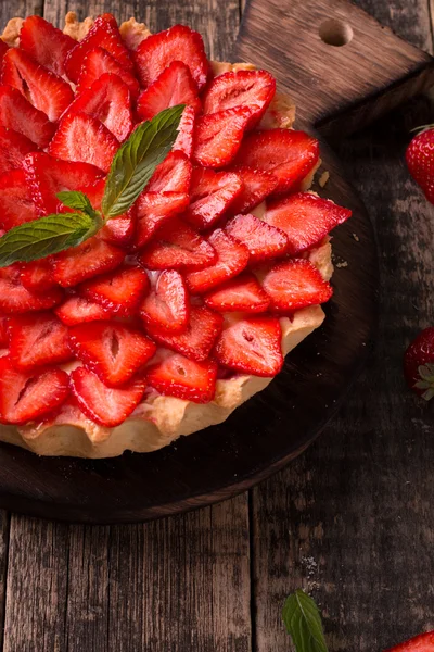 Tarta con fresas y crema batida sobre mesa vintage de madera — Foto de Stock