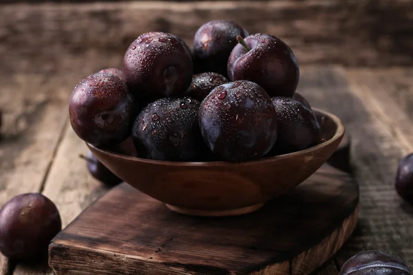 Prunes mûres sur fond vintage en bois — Photo