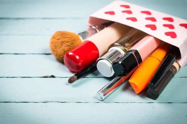 Various makeup products on dark background with copyspace — Stock Photo, Image
