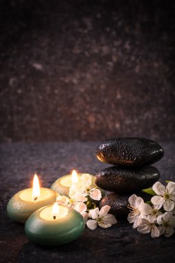 ahşap masa üzerinde taş ve mumlar ile spa konsepti ,