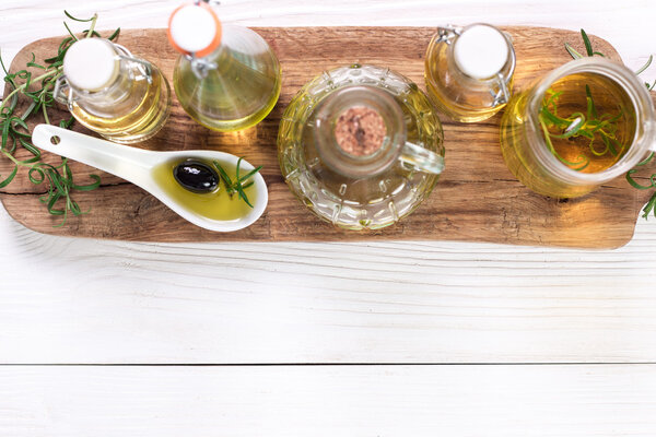 Oils on vintage wooden background . healthy food 