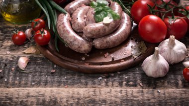 Taze kasap et ürün yelpazesine ahşap masa üzerinde taze biberiye ile süslenmiş kesmek