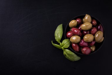 Fesleğen ile ahşap karanlık tabloda zeytin