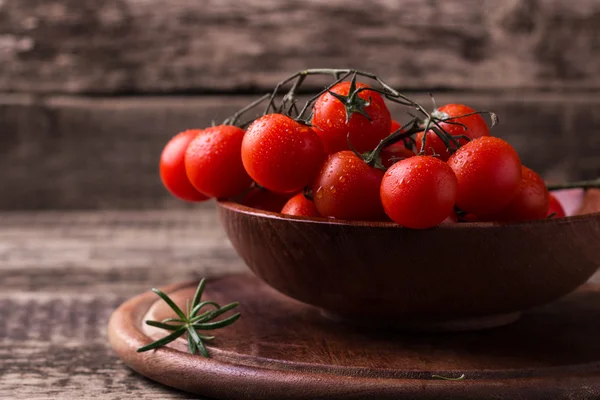 Cherry rajčata na dřevěném pozadí — Stock fotografie