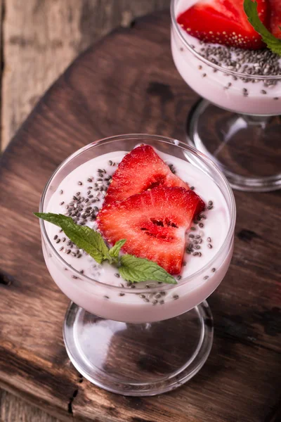 Healthy breakfast or morning snack with chia seeds strawberries yogourt vegetarian food, diet and health concept