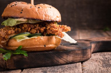 Lezzetli ızgara burger marul ve mayonez, rustik ahşap bir masa üzerinde