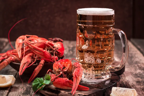 Gekochte Krebse und Bier auf einem hölzernen Hintergrund — Stockfoto
