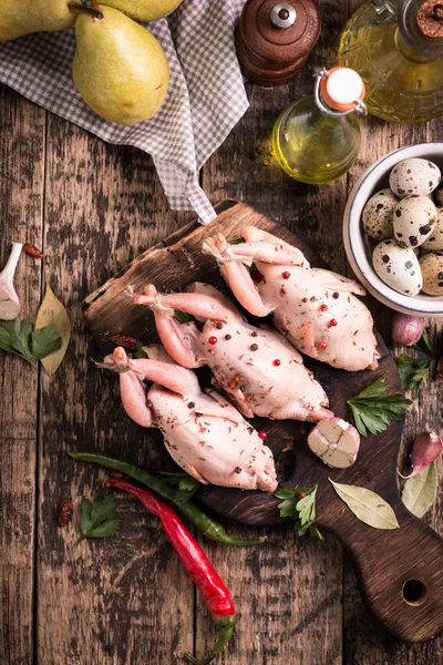 Fresh organic quails on vintage wooden table, healthy food — Stock Photo, Image