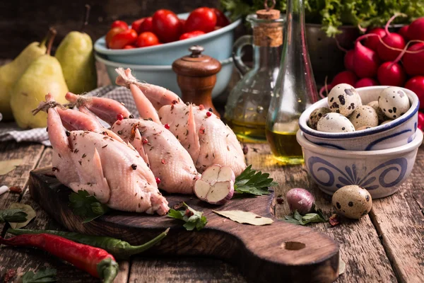 Fresh organic quails on vintage wooden table, healthy food — Stock Photo, Image
