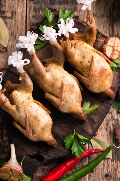 Fresh organic quails on vintage wooden table, healthy food