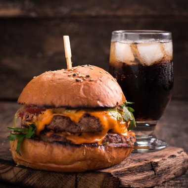 hamburger ya da çizburger ve meşrubat vintage ahşap masa üzerinde Fast food