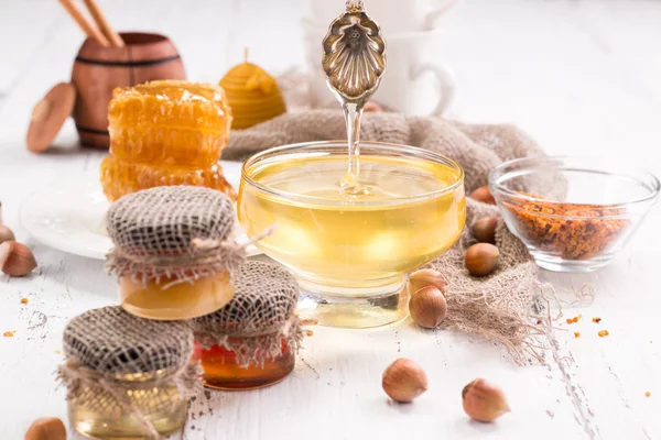 Pot met honing met honingraat op houten tafel — Stockfoto