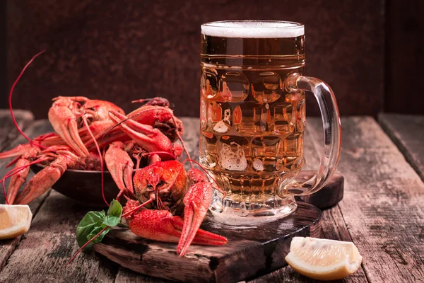 Gekochte Krebse und Bier auf einem hölzernen Hintergrund — Stockfoto