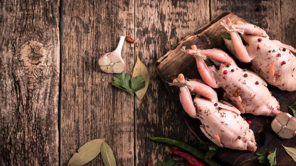 Fresh organic quails on vintage wooden table, healthy food — Stock Photo, Image