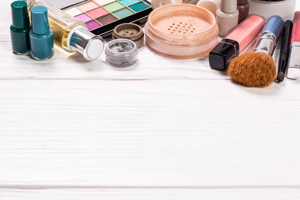 Various makeup products on dark background with copyspace — Stock Photo, Image