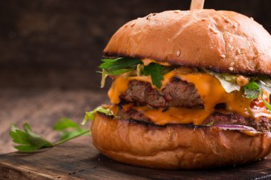 Lezzetli ızgara burger marul ve mayonez, rustik ahşap bir masa üzerinde