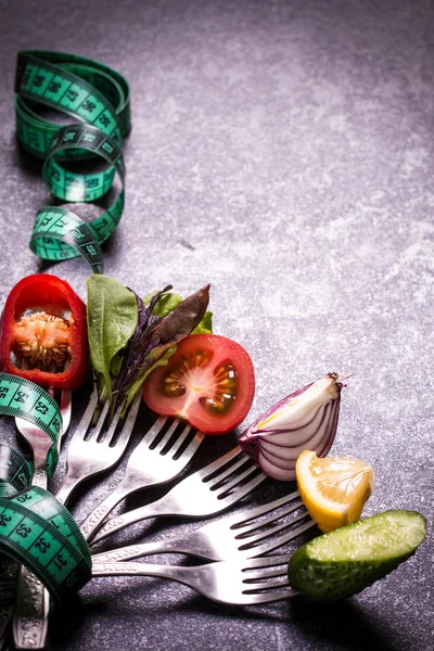 Fresh mixed vegetables on fork ,black background