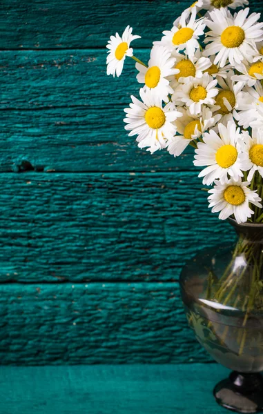 Beautiful bouquet of chamomile on vintage wooden table — Stock Photo, Image