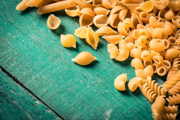 Various mix of pasta on wooden rustic background. Diet and food — Stock Photo, Image