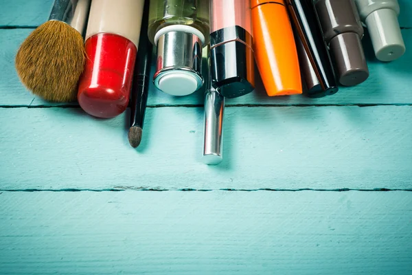 Various makeup products on dark background with copyspace — Stock Photo, Image