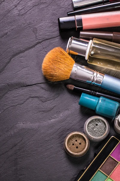 Various makeup products on dark background with copyspace — Stock Photo, Image