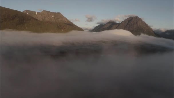 Aerial shot through cloud inversion revealing buachaille etive mor — Stock Video