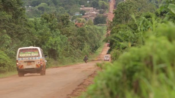 Tarafından geçen bir otobüs ile kırsal Uganda'da düz uzun bir yol — Stok video