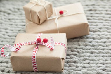 Örgü arka planda kurdeleli hediye kutuları. Noel ve yeni yıl hediyeleri. Doğum günü tebrikleri ve hediyeleri.