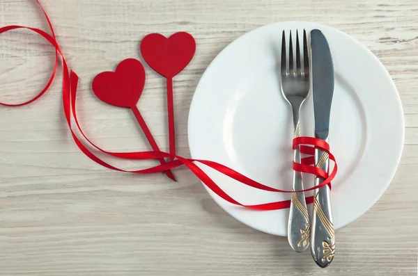 stock image valentines day table setting with heart shaped fork and knife on wooden background