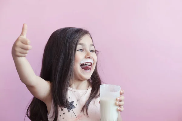 Little Smiling Girl Drinking Milk Glass 스톡 이미지