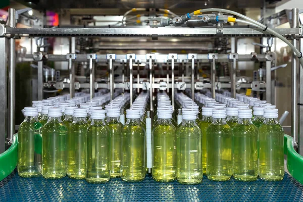 energy drink bottle on the conveyor belt in the production line machine ready for labeling and packing at beverage manufacturing. food and beverage factory and industry concept.