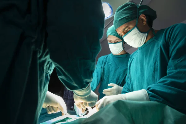 concentrated professional surgical doctor team operating surgery a patient in the operating room at the hospital. healthcare and medical concept