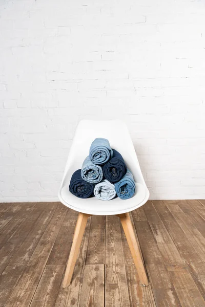 White Chair Rolled Denim Clothing Wooden Floor Brick Wall — Stock Photo, Image