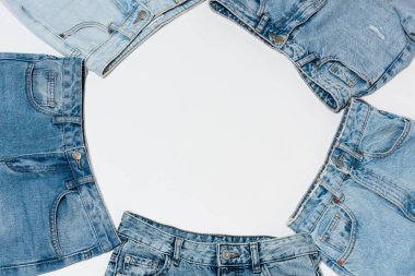 empty frame made from various blue jeans on white background, top view clipart