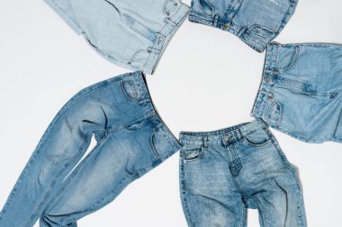 top view of empty frame from various blue jeans on white background clipart